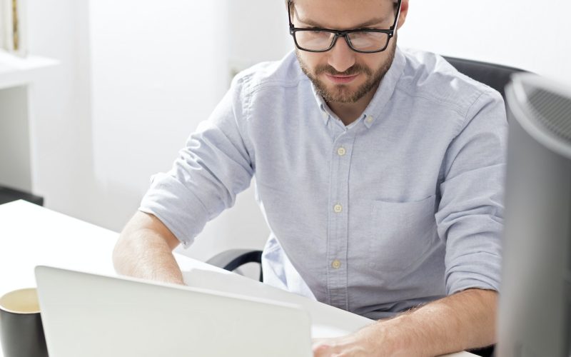 Accountant and bookkeeper using a laptop in the office