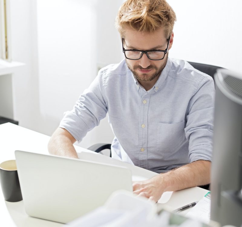 Accountant and bookkeeper using a laptop in the office