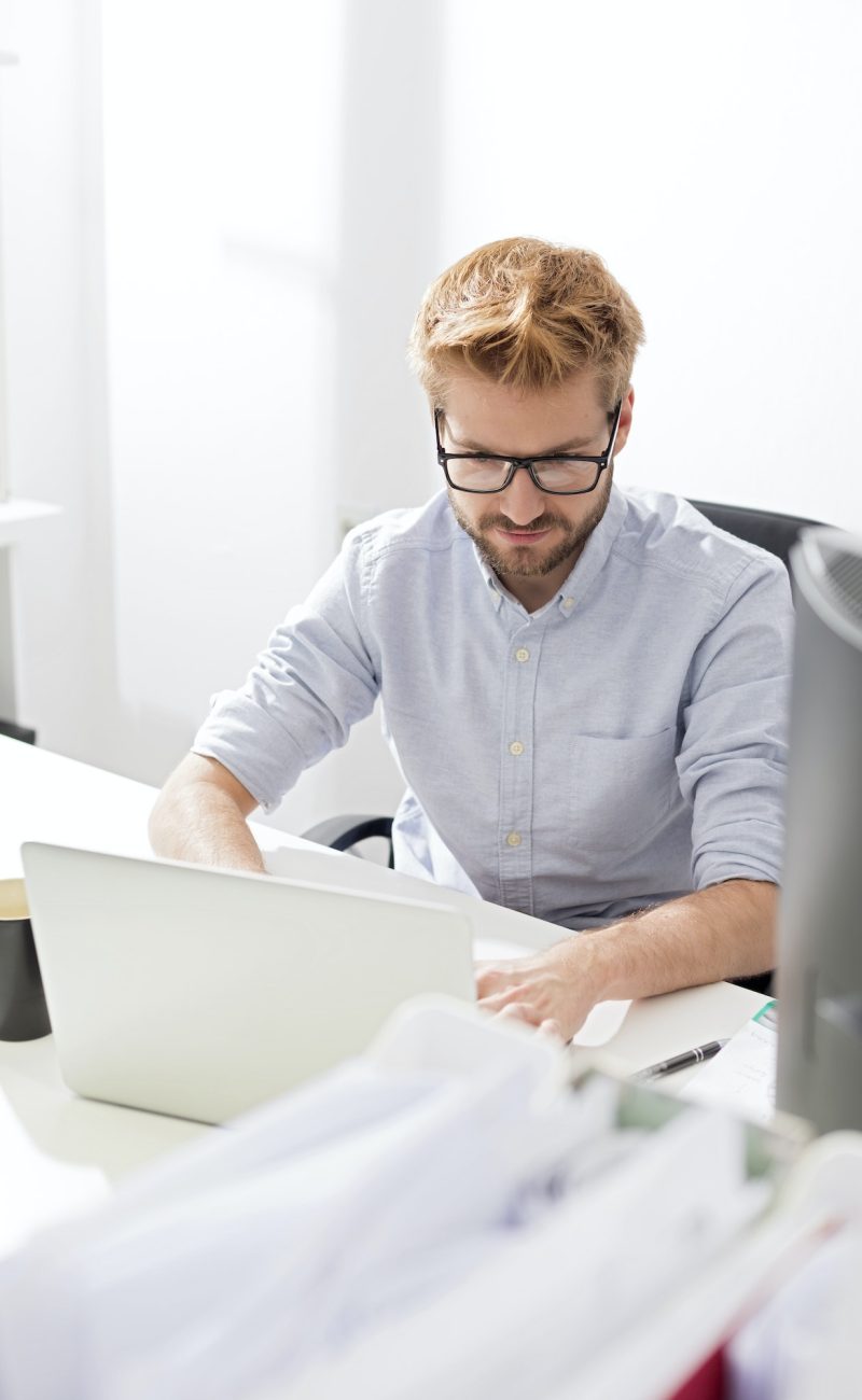 Accountant and bookkeeper using a laptop in the office