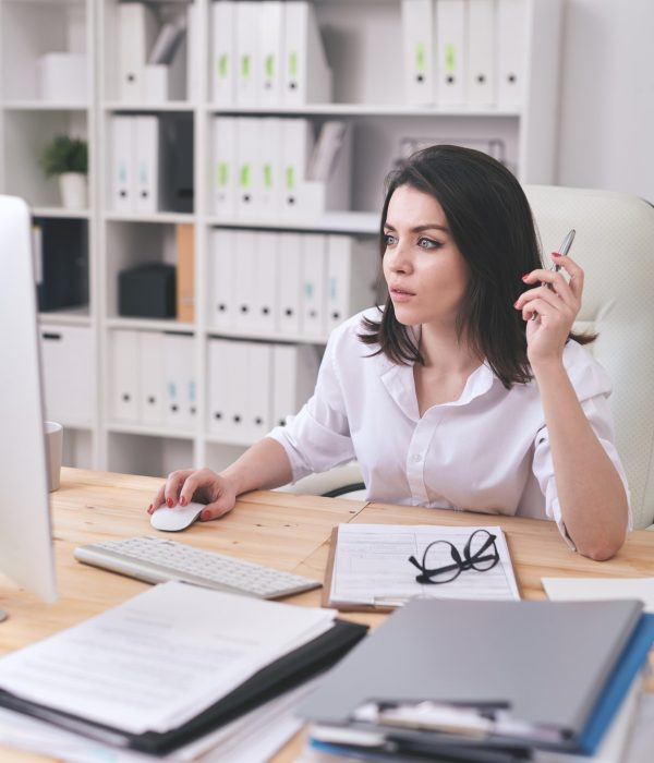 Young female accountant or financial analyst sitting in front of computer Young female accountant or financial analyst sitting in front of computer for bookkeeping services