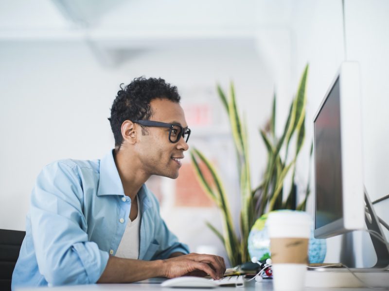 Young man working at computer in office, Accountants for Lawyers, bookkeeping for eCommerce, Accountants for Hairdressers