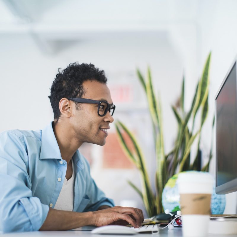 Young man working at computer in office, Accountants for Lawyers, bookkeeping for eCommerce, Accountants for Hairdressers